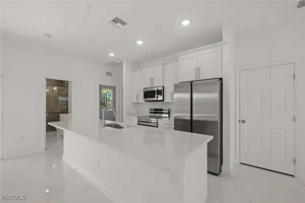 a kitchen with stainless steel appliances a refrigerator and a sink
