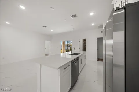 a kitchen with a sink and refrigerator