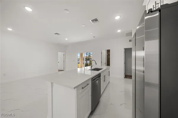 a kitchen with a sink and refrigerator