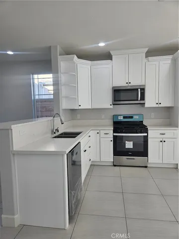 a kitchen with a sink stove and cabinets