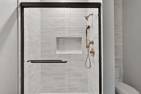 a bathroom with a glass shower door