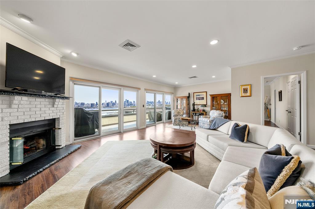 a living room with furniture a fireplace and a flat screen tv