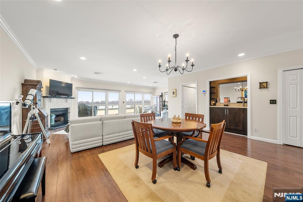 300 Gorge Road, Unit 57 Cliffside Park, NJ 07010 - Photo 14 of 30 a view of a dining room with furniture a kitchen and chandelier