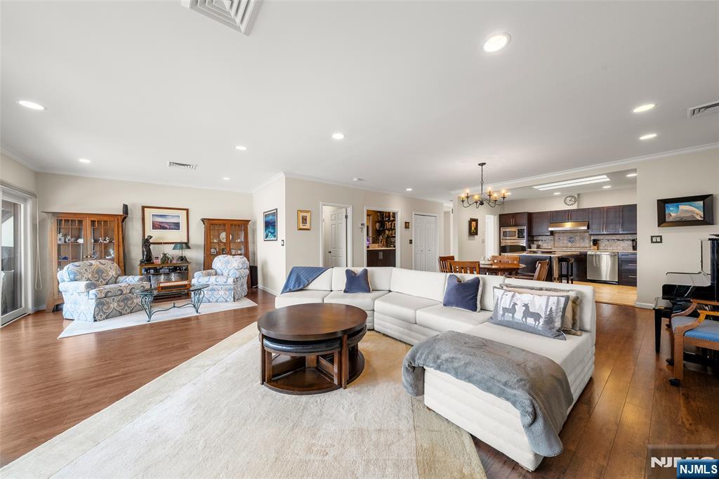 300 Gorge Road, Unit 57 Cliffside Park, NJ 07010 - Photo 15 of 30 a living room with furniture and a dining table with wooden floor