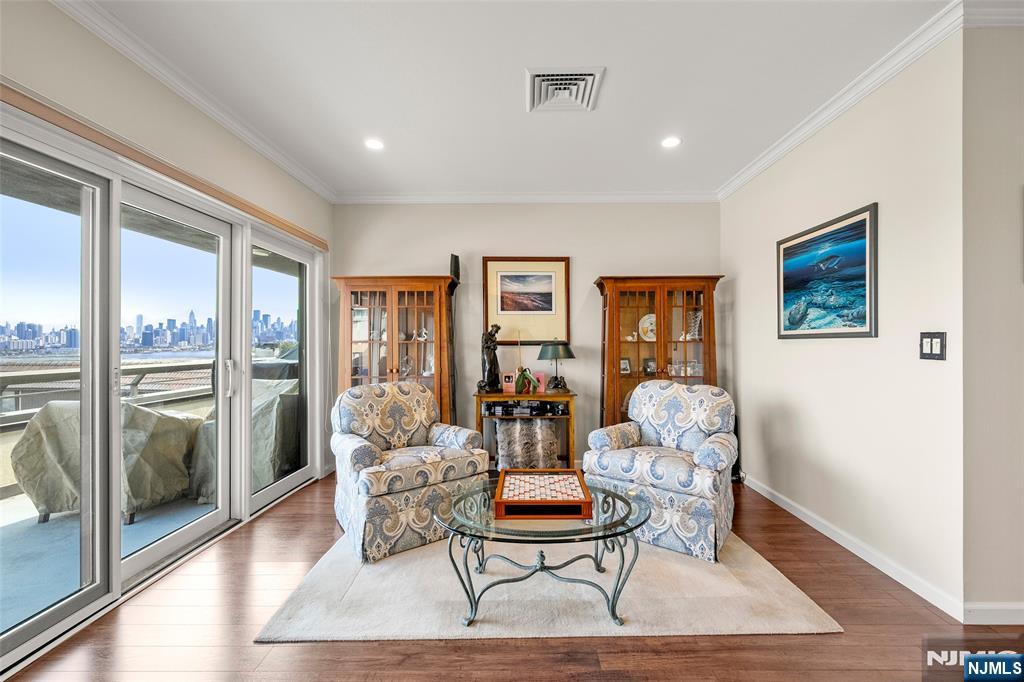 300 Gorge Road, Unit 57 Cliffside Park, NJ 07010 - Photo 16 of 30 a living room with furniture a rug potted plant and a large window