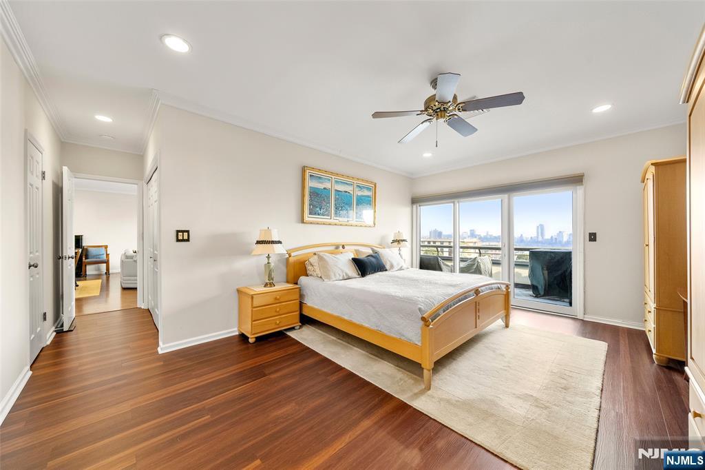 300 Gorge Road, Unit 57 Cliffside Park, NJ 07010 - Photo 17 of 30 a spacious bedroom with a bed and a chandelier