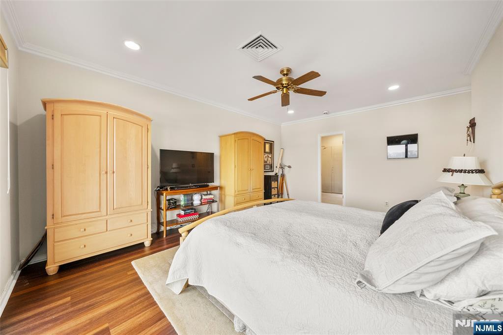 300 Gorge Road, Unit 57 Cliffside Park, NJ 07010 - Photo 18 of 30 a bedroom with a bed a dresser and flat screen tv