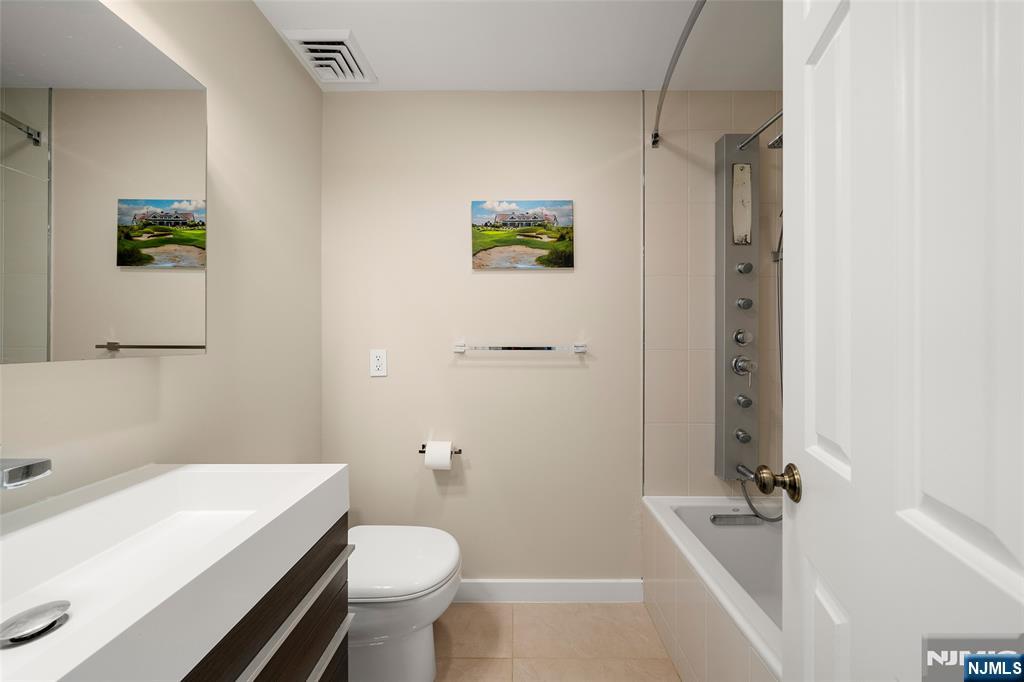 300 Gorge Road, Unit 57 Cliffside Park, NJ 07010 - Photo 21 of 30 a bathroom with a sink a toilet and shower