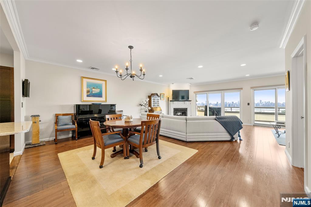 300 Gorge Road, Unit 57 Cliffside Park, NJ 07010 - Photo 6 of 30 a living room with furniture a dining table and a chandelier