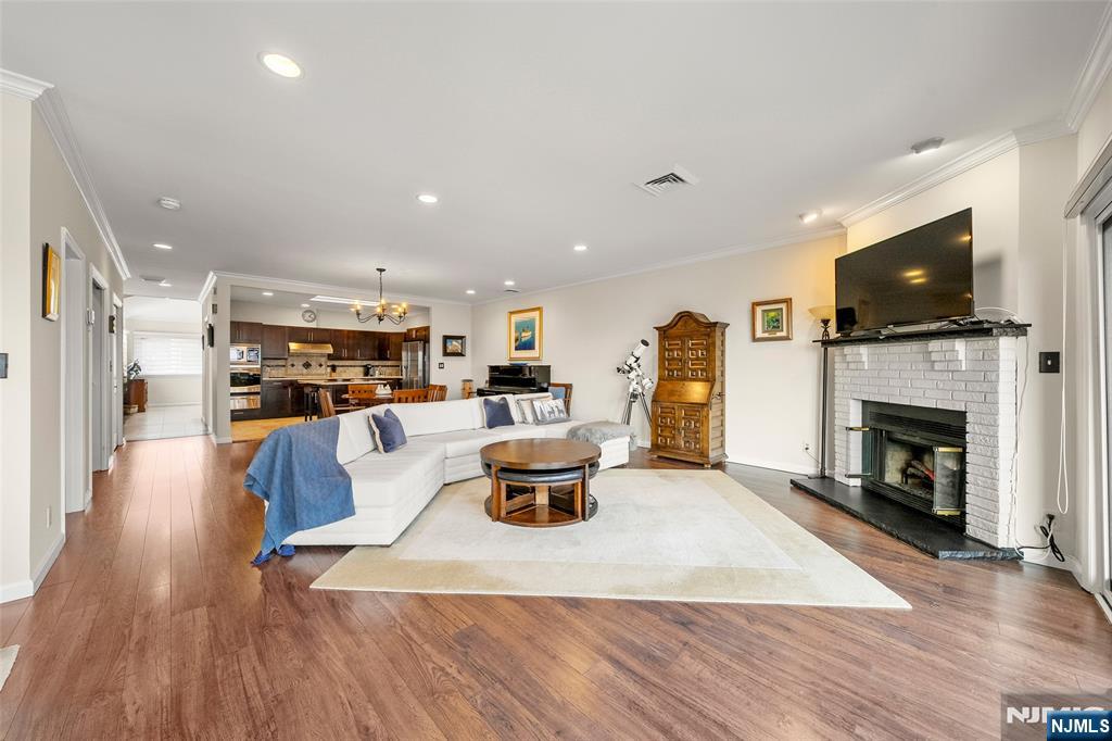 300 Gorge Road, Unit 57 Cliffside Park, NJ 07010 - Photo 8 of 30 a living room with furniture a flat screen tv and a fireplace
