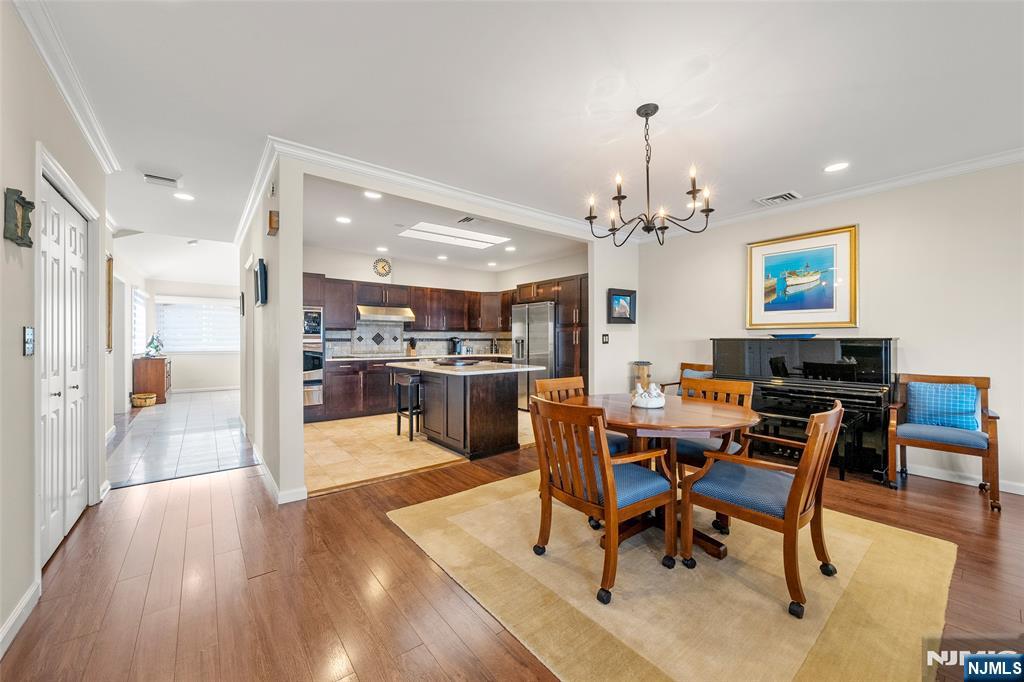300 Gorge Road, Unit 57 Cliffside Park, NJ 07010 - Photo 9 of 30 a view of a dining room with furniture and wooden floor
