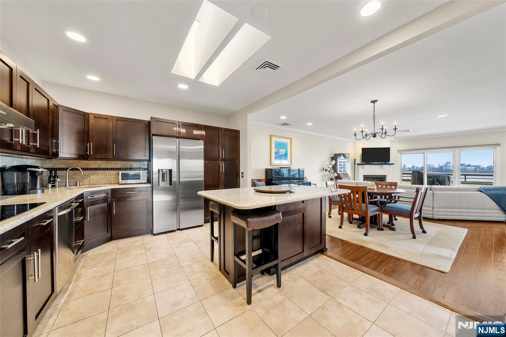 300 Gorge Road, Unit 57 Cliffside Park, NJ 07010 - Photo 10 of 30 a kitchen with stainless steel appliances granite countertop a stove refrigerator and a sink