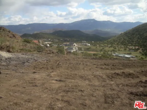 a view of a town with mountains in the background