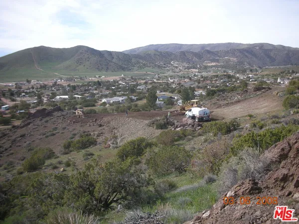 a view of a town with mountains in the background