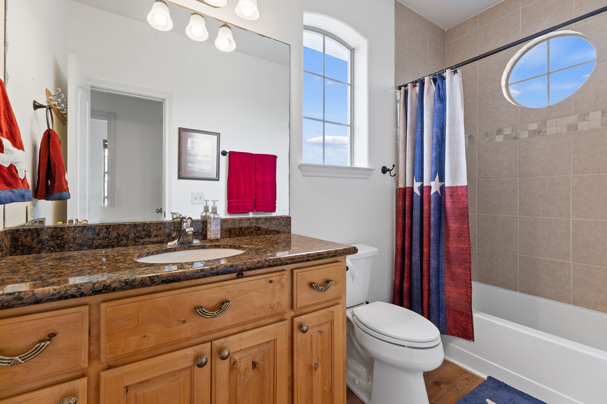 17308 St Therese Road Manor, TX 78653 - Photo 29 of 40 a bathroom with a granite countertop sink mirror vanity and toilet