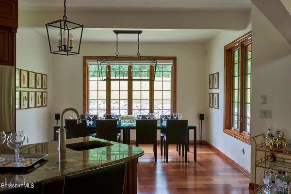 a dining room with furniture a chandelier and wooden floor