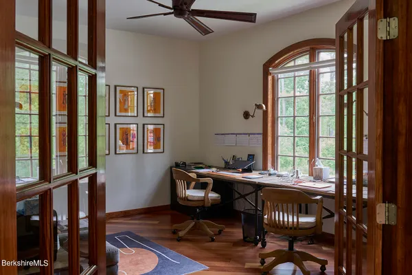 a dining room with furniture window and wooden floor