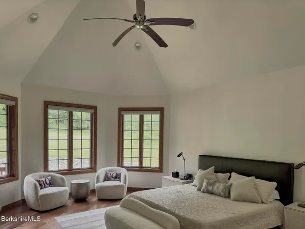 a bedroom with bed couch and window