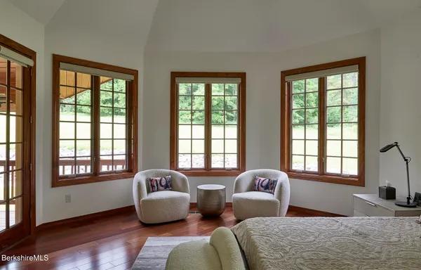 a bedroom with two beds and large window