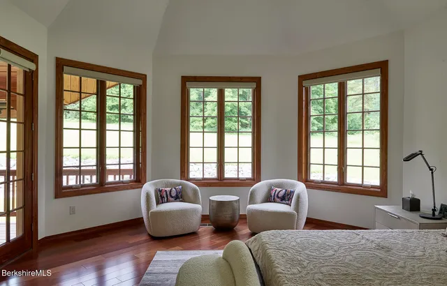 a bedroom with two beds and large window