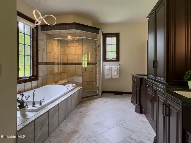 a bathroom with granite countertop a sink and a mirror
