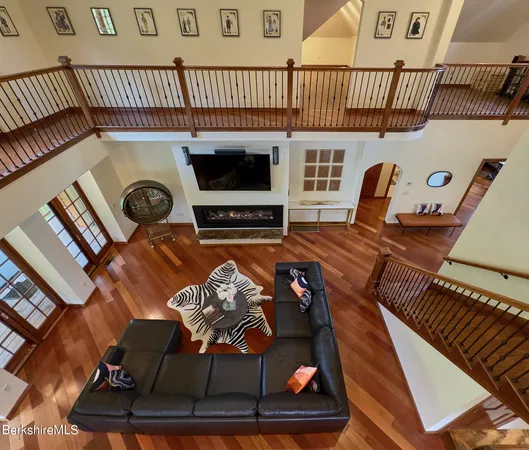 a bedroom with a bed window and a chandelier