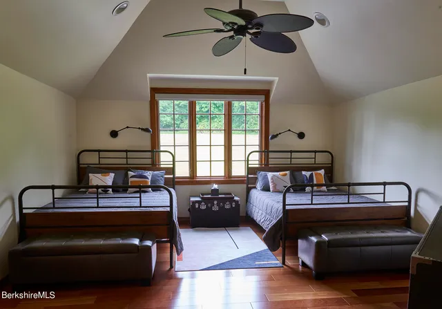a bathroom with a granite countertop sink a mirror and shower