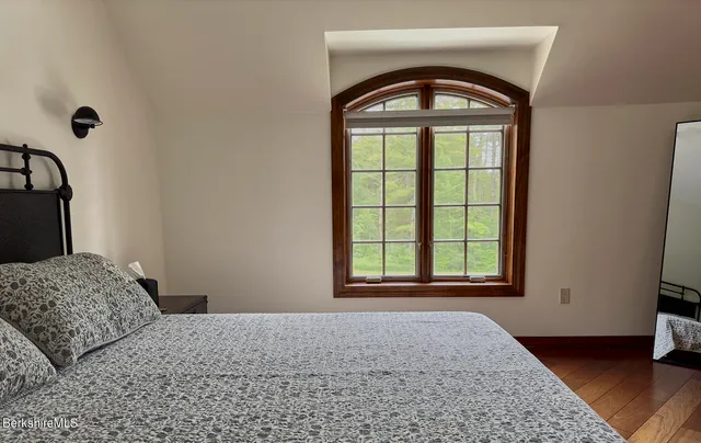 a bathroom with a granite countertop sink mirror and window