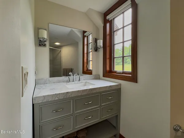 a bedroom with a bed and a mirror