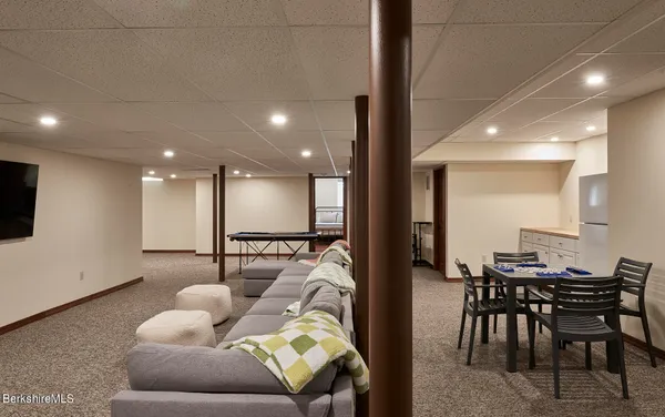 a view of a house with a big yard and large trees