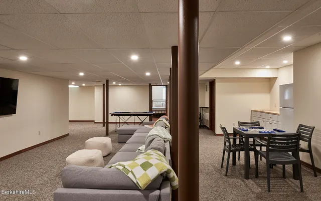 a view of a house with a big yard and large trees