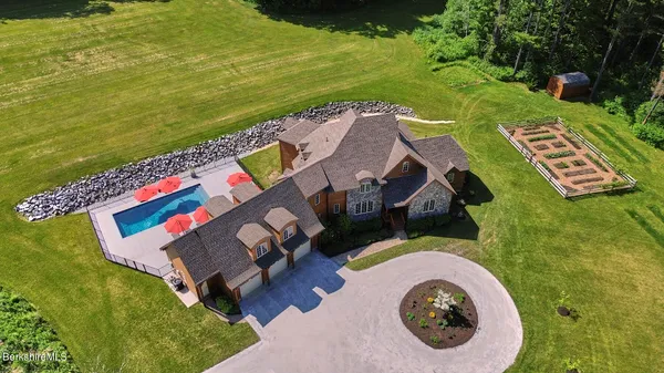 an aerial view of a house with outdoor space swimming pool and ocean view