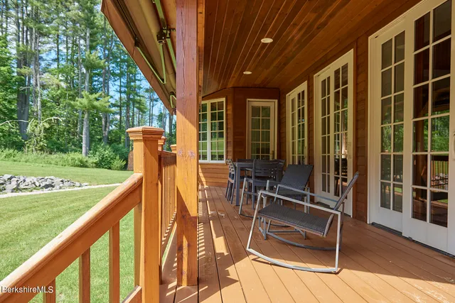 a view of a house with backyard sitting area and swimming pool