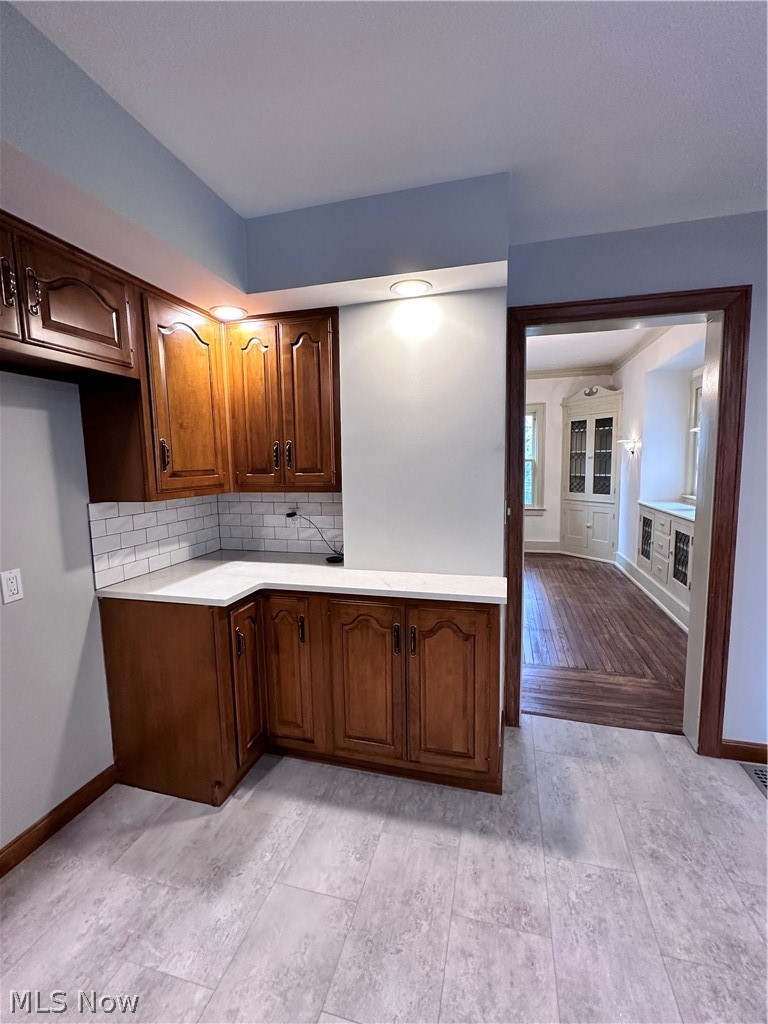 910 Cambridge Road Coshocton, OH 43812 - Photo 9 of 30 Kitchen featuring light wood-type flooring and tasteful backsplash