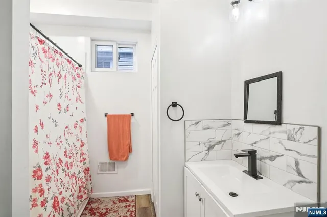 a bathroom with a sink and mirror