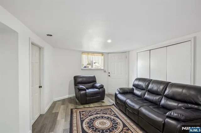 a living room with furniture a rug and a window