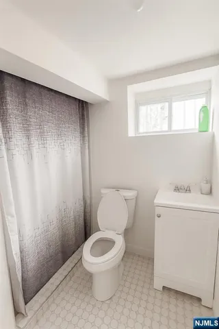 a white toilet sitting next to a bathroom sink