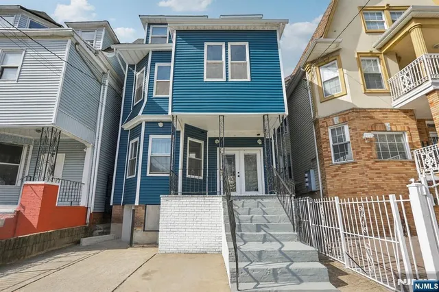 a view of a brick house with large windows