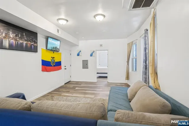 a living room with furniture and wall painting