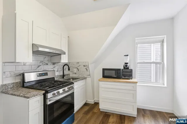 a room with wooden floor and white walls