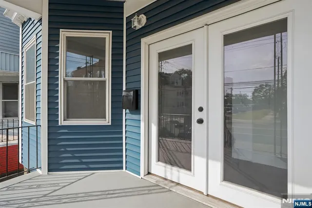 a view of a brick house with a glass door