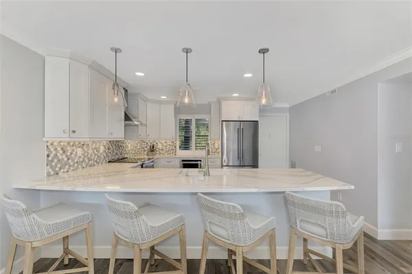 a kitchen with stainless steel appliances a refrigerator sink and cabinets