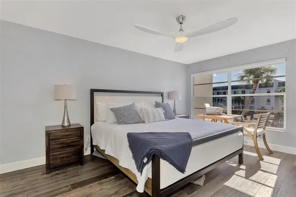 a bedroom with a bed and a large window