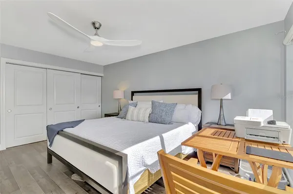 a bedroom with a bed and a ceiling fan