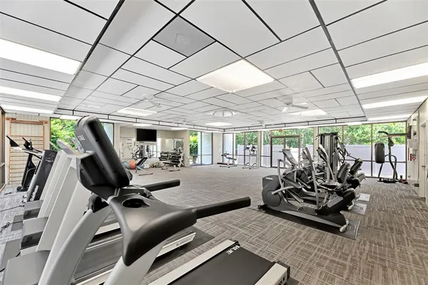 a view of a lake in front of a house with a yard