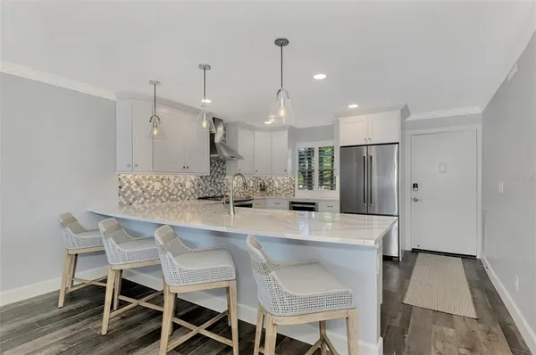 a kitchen with stainless steel appliances a stove a sink and a refrigerator