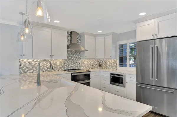 a kitchen with counter top space and stainless steel appliances