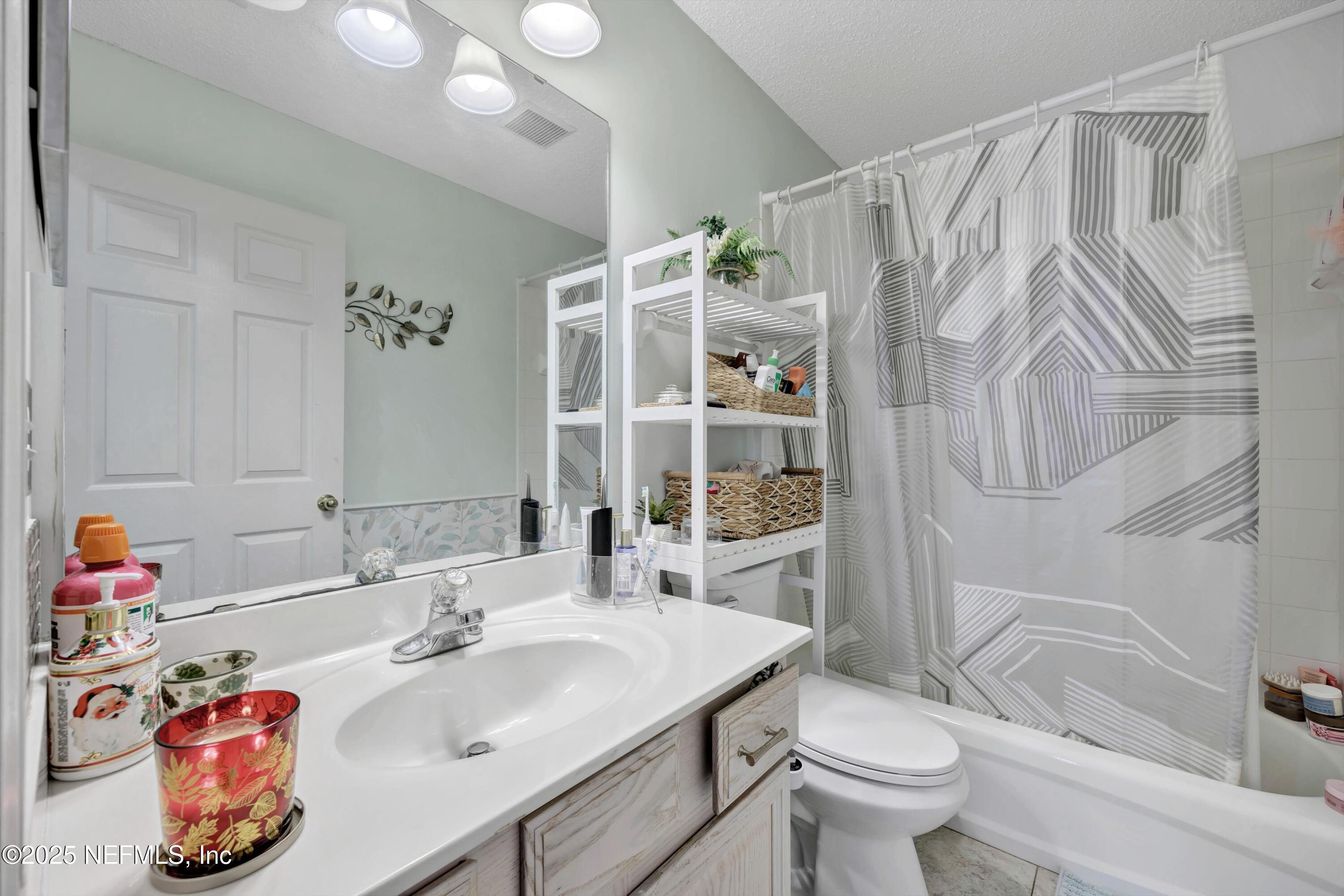 1374 Brookgreen Way Fleming Island, FL 32003 - Photo 10 of 21 a bathroom with a sink toilet and shower