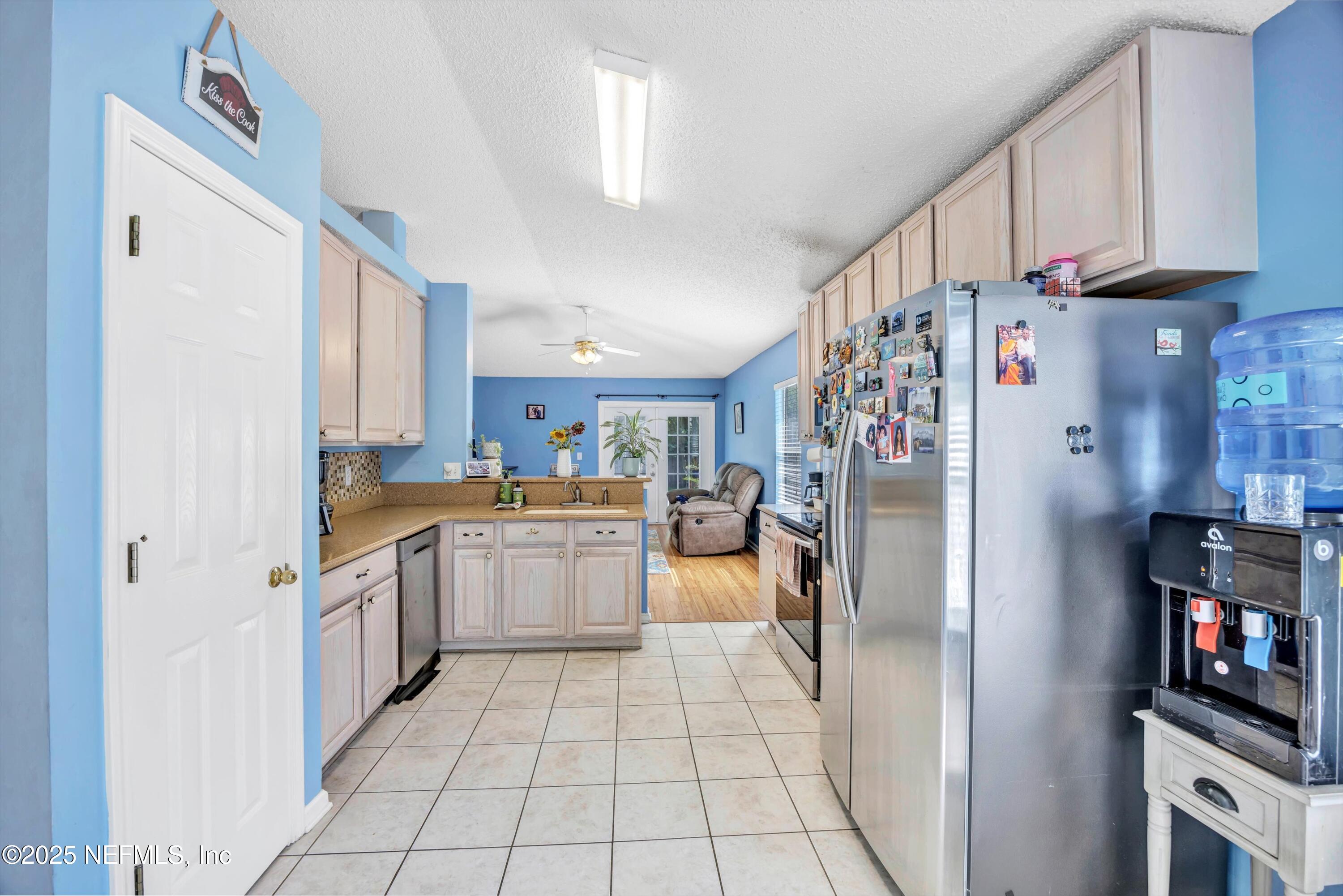 1374 Brookgreen Way Fleming Island, FL 32003 - Photo 18 of 21 a kitchen with stainless steel appliances granite countertop a refrigerator and a sink
