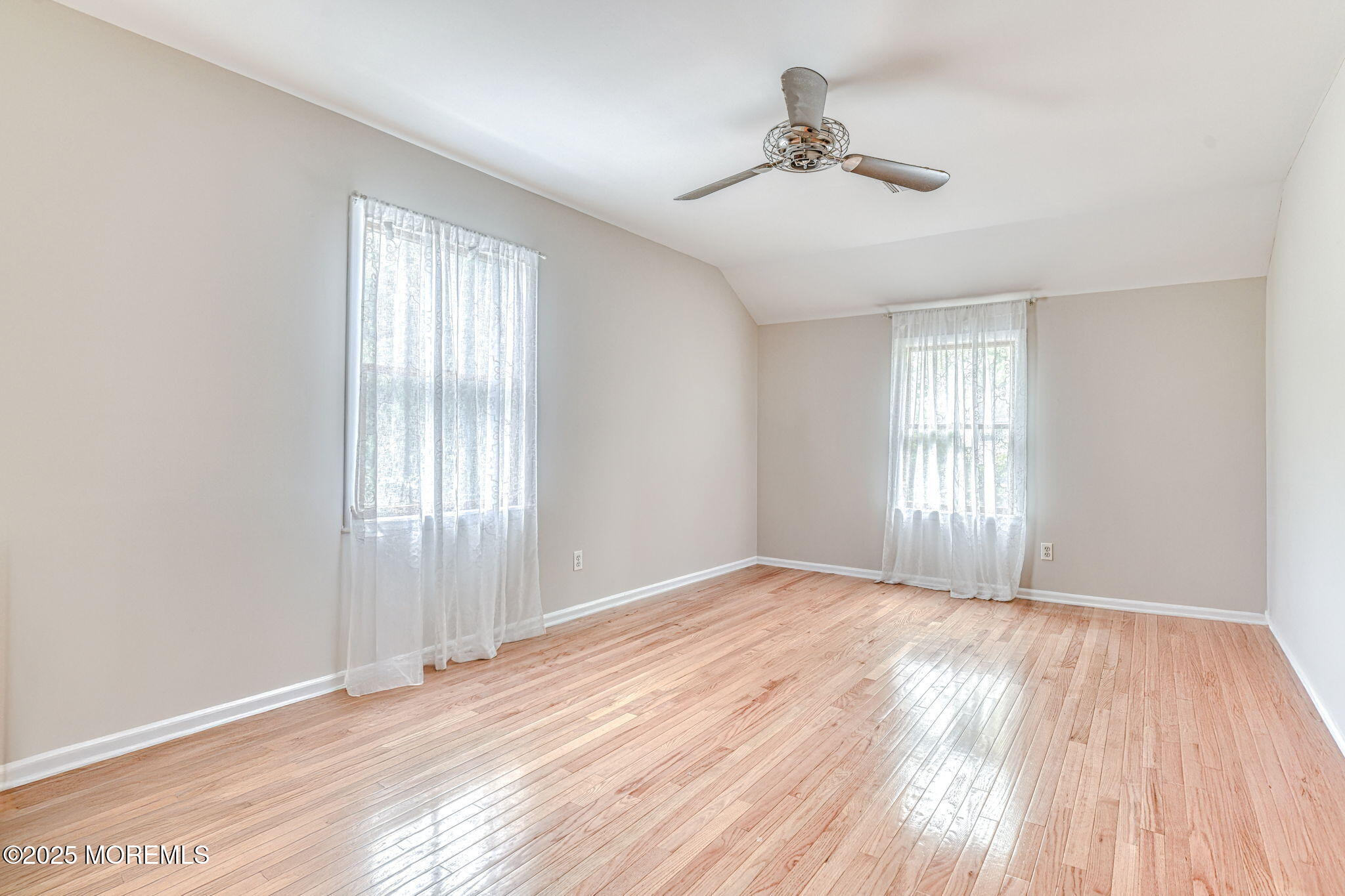 24 Peach Tree Road Oakhurst, NJ 07755 - Photo 12 of 34 a view of an empty room with a window and wooden floor